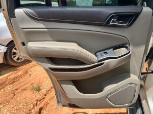 2015-2020 GMC Yukon Tan Door Interior Trim Panel - Rear, Left (Driver) (Used OEM)