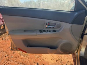 2004-2009 Kia Spectra Tan Door Interior Trim Panel - Front, Left (Driver) (Used OEM)