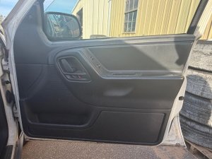 1999-2004 Jeep Grand Cherokee Black Door Interior Trim Panel - Front, Right (Passenger) (Used OEM)