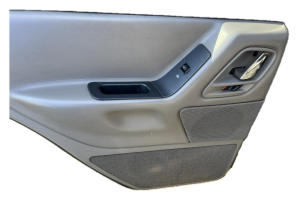 1999-2004 Jeep Grand Cherokee Tan Door Interior Trim Panel with Power Windows - Rear, Left (Driver) (Used OEM)